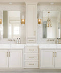 Bathroom vanity with two sinks featuring brushed gold wall sconce with clear glass cylinder shade 1 light modern transitional wall fixture