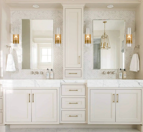 Bathroom vanity with two sinks featuring brushed gold wall sconce with clear glass cylinder shade 1 light modern transitional wall fixture