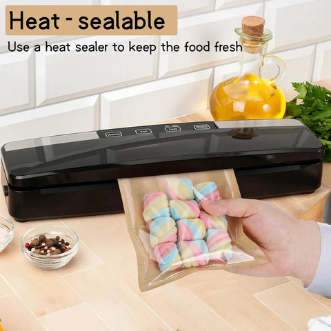 Heat sealer being used to seal a bag of marshmallows on a kitchen counter with olive oil and spices in the background.