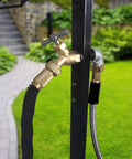 Brass faucet detail on freestanding outdoor hose holder stand with heavy duty metal water hose reel for garden