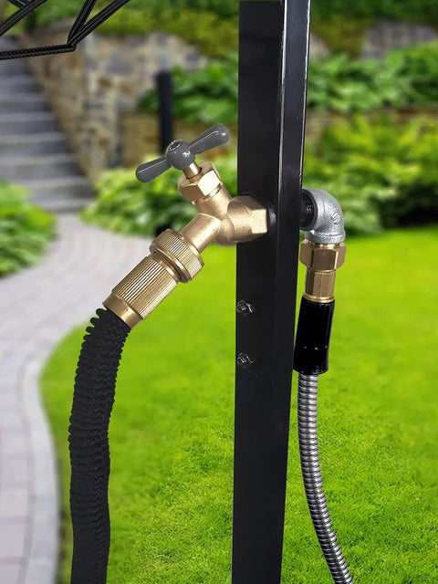 Brass faucet detail on freestanding outdoor hose holder stand with heavy duty metal water hose reel for garden