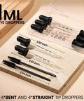 Glass Dropper Set With 10 Pieces Featuring 8 1ml Droppers And 2 Cleaning Tools, visible droppers and cleaning brushes on a board