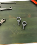 Built Tough Beefy Heavy Duty Stainless Steel Eye Bolt M6x20 With Closed Ring And Hole, Deep Threaded Mount, Includes Flat Washer, Spring Washer And Nylon Nut, Rugged Rigging Hardware For Hoists, Anchors, And Outdoor Installations. M6 eye bolts on green wood