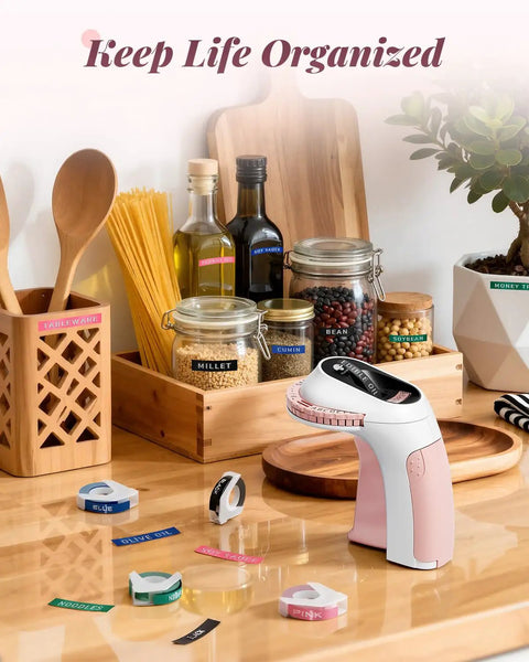 Vintage Embossing Label Maker With Six Adhesive Tape Rolls Manual Typewriter Style Sticker Gun on kitchen table with jars and labels.