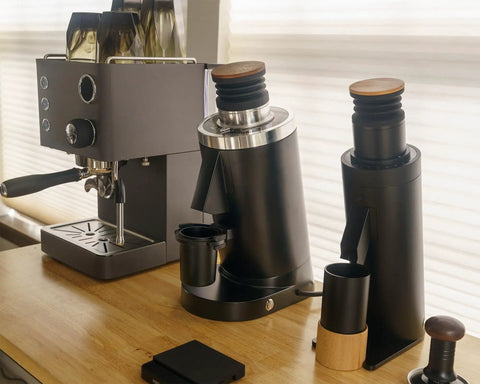 Top Shelf Single Dose Coffee Grinder Equipped With 83Mm Red Titanium Flat Burrs And Integrated Plasma Ionizer Chute For Zero Static Clumps Ideal For Home Brew Crews Chasing Consistent Pulls Without Any Headache In Classic Black on a kitchen countertop with espresso machine.
