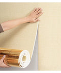Hand applying Premium Beige Thermal Peel And Stick Wall Panels 9mm Thick XPE Foam Insulation to a wall for easy installation.