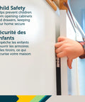 Child's hand attempting to open a cabinet door secured with an Adhesive Cabinet Latch Set 4 Piece For Childproofing White Peel And Stick Easy