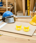 Emergency Stop Button Cover Kit 20 Pieces With Easy Universal Installation And Impact Protection In Bright Yellow For Industrial Control Panels And Machinery Safety, two yellow covers on workbench