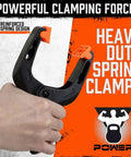 Hand holding Six Pack Heavy Duty Spring Clamps, 7 Inch Plastic Clamps with 3.7 Inch Jaw Opening, close-up view