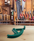 Portable Manual Steel Pipe Bender For Copper And Aluminum Tubes With Ergonomic Grip on workbench in tool shop.