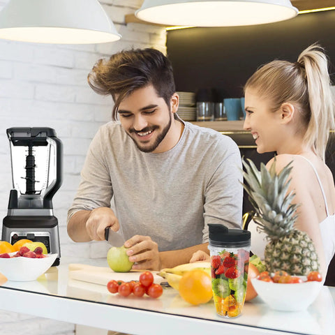 Couple preparing fruit with 2 Pack 24 Oz Blender Cups With Lids And Cup Brush For Auto IQ Blenders Fits Models BL450 BL454 BL456
