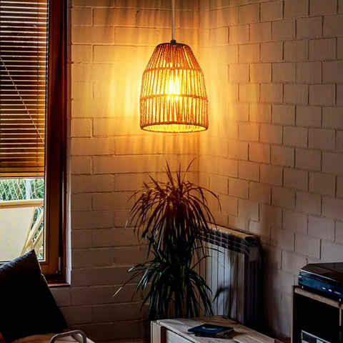 Hand Woven Hemp Rope Pendant Light With 15 Foot Golden Cord And Stepless Dimmer Switch illuminates a cozy room.