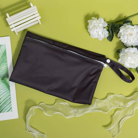 Waterproof Wet Dry Bag For Swimwear And Travel, Reusable Leakproof Organizer For Strollers, Diapers, Black on green background