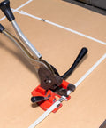 Heavy Duty White Polypropylene Strapping Roll 9900 Ft 1/2 Inch 440 Lb Tensile Strength packing tool on cardboard.