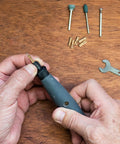 Hands using 10 Pack Brass Dope Drill Chuck Collet Set for Rotary Tools and Electric Drills Fits One Eighth Inch and Three Point Two Millimeter
