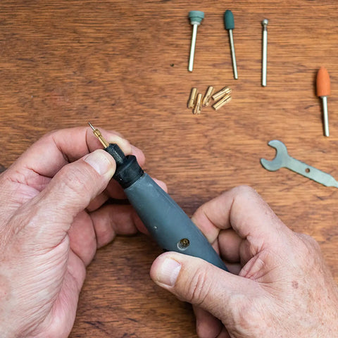 Hands using 10 Pack Brass Dope Drill Chuck Collet Set for Rotary Tools and Electric Drills Fits One Eighth Inch and Three Point Two Millimeter