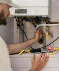 Man using Heavy Duty Brass Ball Valve Three Eighths Inch Full Port With Female To Female NPT Threads in plumbing setup