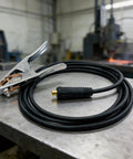 Heavy Duty 200A Ground Clamp With Thick Rubber Insulation And Firm Grip Handle For Safe Welding Jobs on a metal table.
