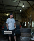 Solid Aluminum Tool Box Featuring A Slick Padded Interior And Extra Sturdy Reinforced Handle held by a man in a garage.