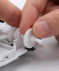Top-Shelf Mini Plastic Gear Kit With Mechanical Project Parts Small Motor Components And DIY Hobby Accessories For School Engineering Models with a hand assembling gears.