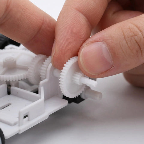 Top-Shelf Mini Plastic Gear Kit With Mechanical Project Parts Small Motor Components And DIY Hobby Accessories For School Engineering Models with a hand assembling gears.