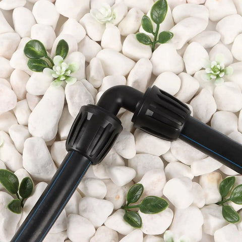 14 Pack One Half Inch Drip Tubing Elbow Fittings With Barbed Lock Nuts For Garden Irrigation Systems One Half Inch ID By Sixteen Millimeter OD 90 Degree Elbows No Brainer Install Anti Drop Connectors For Lawn on white stones with green leaves