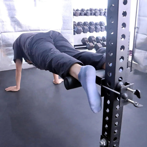 Person using upgrade hamstring curl sit up bar attachments for power racks with pin rod and 3 adjustable holes for core workout