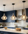 WILON 11" Hammered Glass Pendant Lights Kitchen Island Black hanging above a kitchen island with modern décor and food items.