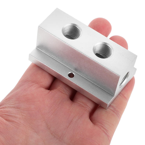 T Type Pneumatic Gas Manifold With Two Position Four Port Air Distribution Block in hand, showcasing compact size and durable design