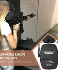 Woman wearing Gel Ear Seals Shooting Earmuffs With NRR 26dB Noise Reduction, aiming a gun at a shooting range, black.