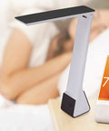 Rechargeable LED Desk Lamp With 3 Color Temperatures, Flip Open Head, Portable Battery Power, USB Cable, Black next to bed and phone