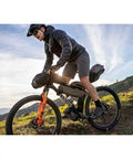 Cyclist on mountain bike with Green 4.5L Bike Frame Bag With Water Resistant Poly Nylon Build Easy Access Pocket Secure Hook And Loop Mounting