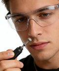 Person holding Pro Grade Diamond Coated Rotary Burr Set with 1.6mm shank bit, wearing safety glasses