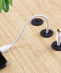 Premium Flexible Silicone Cable Cord Grommet Set 1 Inch Black with white USB-C cable on wood desk for wire management.