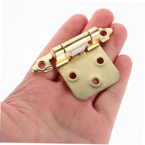 Mobestech brass semi-hidden spring-loaded cabinet hinge with mounting holes, held in hand