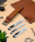 Pro Grade Leather Punch Set With Steel Hollow Punches, Three Piece Grommet Hole Punch Kit on wooden surface with leather and tools