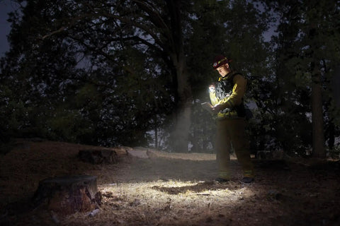 Person using a Compact Two Cell AA LED Flashlight With Adjustable Focus And Precise Beam For Emergency Prep EDC Outdoor Camping And Hiking