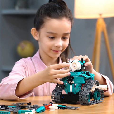 3 In 1 RC Robot Kit For Kids Ages 8-12 With 440 Pieces, Build A Sleek Robot Car, A Tank, Or A Robot Girl With Bow Hair Clip, Epic STEM Toy Gift For Boys And Girls, Educational And Hands On Fun. Child assembling teal tracked robot toy