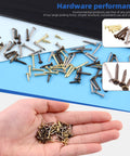 Hand holding small gold, silver, and bronze nails with scattered 1600Pcs Tiny Nails Kit With 1x6mm 1x8mm 1x10mm Wooden Nails In Gold Silver Bronze.