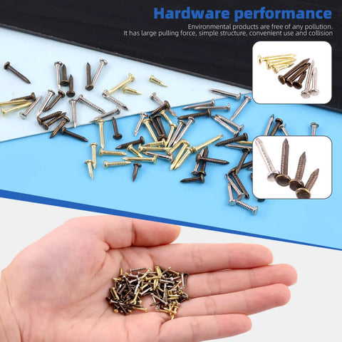 Hand holding small gold, silver, and bronze nails with scattered 1600Pcs Tiny Nails Kit With 1x6mm 1x8mm 1x10mm Wooden Nails In Gold Silver Bronze.
