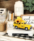 Sunflower Metal Farm Truck Decor Set Of Four with large and mini sunflowers on a yellow vintage diecast pickup in farmhouse kitchen