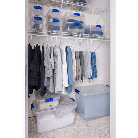 Heavy Duty Clear Plastic Storage Totes Set Of 16 31 Quart Stackable Bins With Latching And Locking Lids For Holiday Decor Linens Clothes And Crafts Plus Easy Carry Handles For Quick Organization in a closet with clothes.