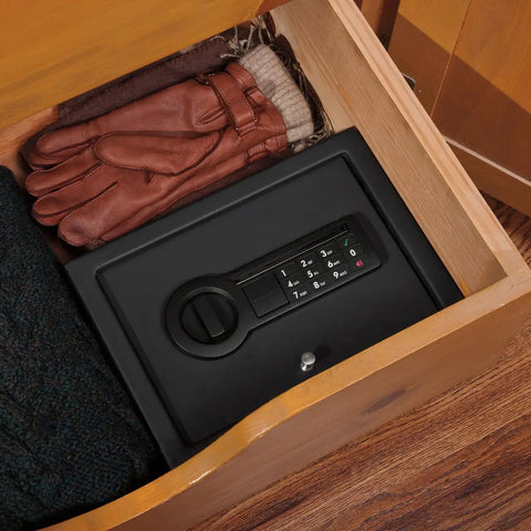 Slick Hidden Drawer Safe With Electronic Lock And Backup Key For Desk Or Nightstand Built Tough From Solid Steel Construction inside a drawer next to gloves.