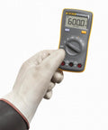 Person holding Palm Sized Digital Multimeter For On The Go Tech Work Measures Voltage Resistance Continuity And Capacitance With 10A Current