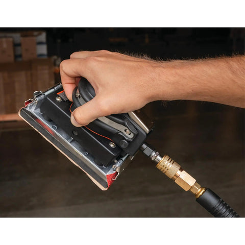 Hand holding Top Shelf Pneumatic Orbital Sander With Built In Air Regulator and Rubber Over Mold Grip for precise sanding.