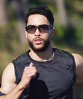 Man running wearing 12 Pack ANSI Z87.1 Safety Glasses For Men And Women Clear And Grey Lens Anti Scratch Eye Protection For Work Lab And Outdoors