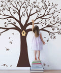 Child reaching up to a Family Tree Wall Decal in Chestnut Brown, 107 Inches Wide By 90 Inches Tall, Matte Vinyl Peel and Stick Wall Art