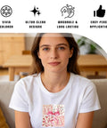 Woman wearing t-shirt with Mama Iron On Transfers For Christian Moms Floral Bow Pack design, sitting on sofa, home background.