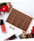 Wooden Multi Grid Ring Holder Tray on a white surface, ideal for storing jewelry and functioning as a cell phone stand.