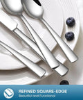 Close-up of 20 Piece Silverware Set for four with knives, forks, and spoons, mirror polished, on a white plate with blueberries